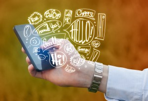 Hand holding phone with hand drawn speech bubbles